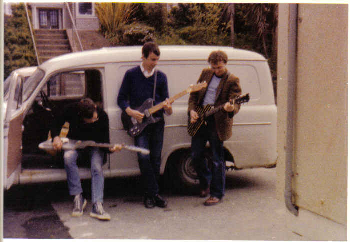 The Killjoys in front of a white Austin van